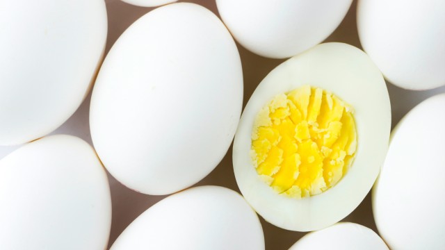 Several white eggs - one with a soft, brilliantly cooked yolk