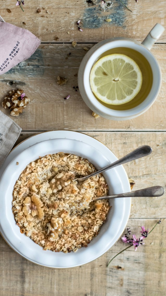 A bowl of cinnamon oatmeal steaming on a table
